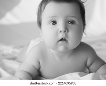 A Small Child Of 5 Months Lies On His Tummy And Controls The Muscles Of The Neck. Beauty And Health Of The Baby. Happy Baby And Mom. The Concept Of Motherhood