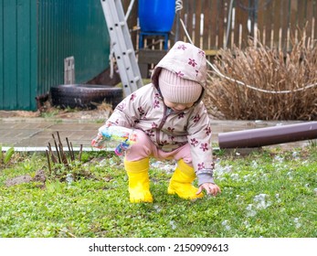 A Small Child Blows Soap Bubbles From A Gun