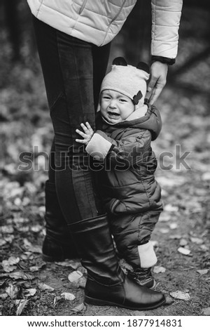 Similar – Image, Stock Photo scared boy hiding in his mom’s dress