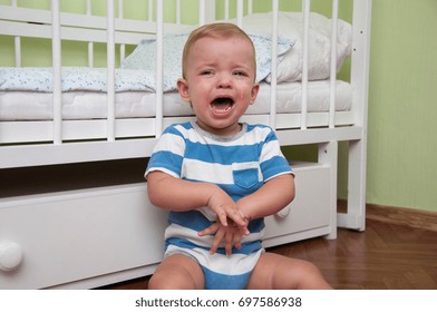 A Small Child Crying Near His Bed
