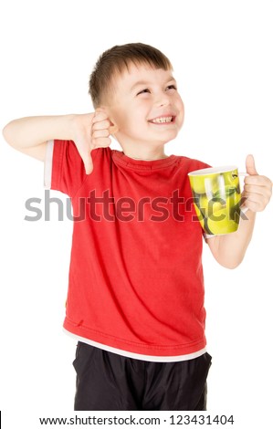 a small child does not like what he drinks isolated on white background