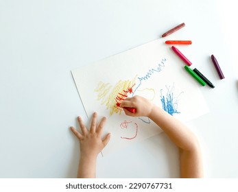 small child draws with pastel crayons on white table. fathers day - Shutterstock ID 2290767731