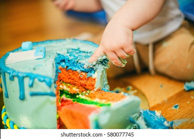 Small child eating cake. Focus on the  cake