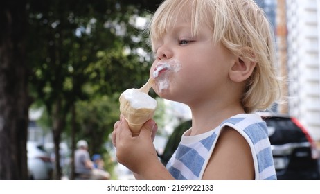 A Small Child Eats White Ice Cream With Great Pleasure Ice Cream On Face