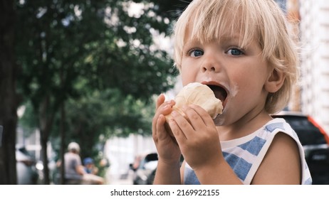 A Small Child Eats White Ice Cream With Great Pleasure Ice Cream On Face