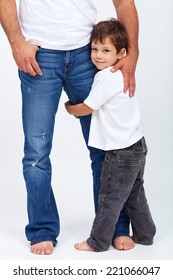 Small Child Holding His Father Leg - The Safety Provided By A Parent