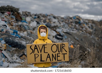 Small child holding placard poster on landfill, environmental pollution concept.