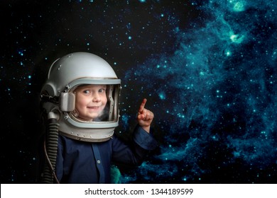 A Small Child Imagines Himself To Be An Astronaut In An Astronaut's Helmet. Elements Of This Image Furnished By NASA