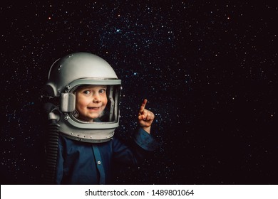 A Small Child Imagines Himself To Be An Astronaut In An Astronaut's Helmet. Elements Of This Image Furnished By NASA