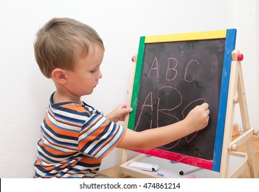 Small Child Learning To Write The Alphabet