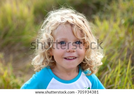 Similar – Small child with long blond hair enjoying of a sunny day