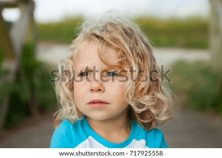 Similar – Small child with long blond hair enjoying of a sunny day