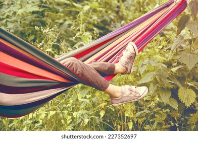 Small Child Lying In A Hammock In The Woods