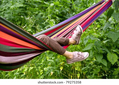 Small Child Lying In A Hammock In The Woods