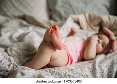 A small child is lying on the bed - Shutterstock ID 1703653408