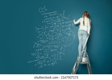 Small Child Math Student Writing Science Formulas On Blue Background