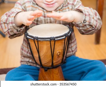 Small Child Playing On Drum. Little Caucasian Boy And Drum. Hands Close Up