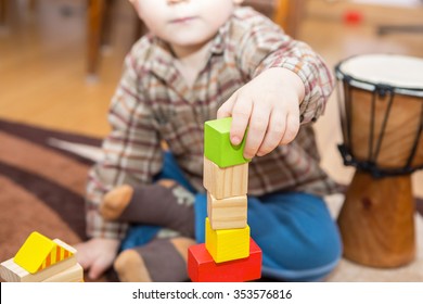 Small Child Playing With Wooden Blocks. Caucasian Boy Building With Blocks