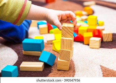 Small Child Playing With Wooden Blocks. Caucasian Boy Building With Blocks