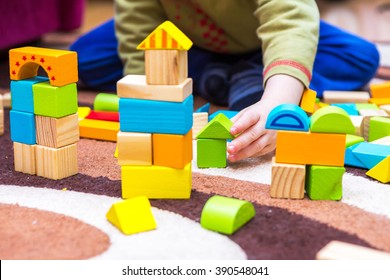 Small Child Playing With Wooden Blocks. Caucasian Boy Building With Blocks