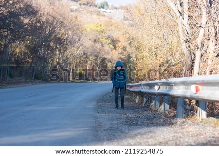 A small child walks alone along the road and cries, ran away from home. Family