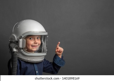 Small child wants to fly an airplane wearing an airplane helmet