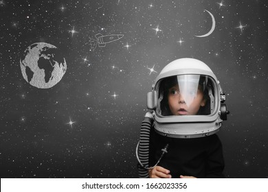 Small Child Wants To Fly An In Space Wearing An Astronaut Helmet