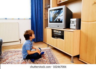 A Small Child Watching Television With Tv
