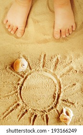 Small Child's Feet In The Sand.