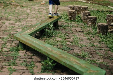 small child's feet are walking on the playground footbridge, path of balance - Powered by Shutterstock