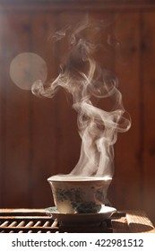 Small chinese teacupand a trickle of steam