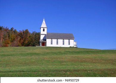 Small church on top of a green hill in West Virginia