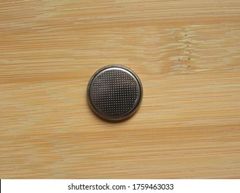 Small circular button battery isolated