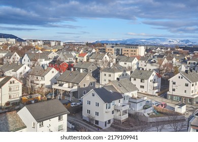 The Small City Of Bodo In Norway With A Cloudy Or Overcast Blue Sky. A Beautiful Scenic View Of Urban Landscape Streets And Buildings With Copy Space. Peaceful Rural Town From Above