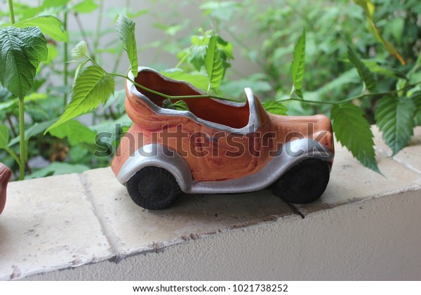 Small clay car garden\
ornament