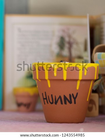 A small clay pot dripped with yellow paint and 