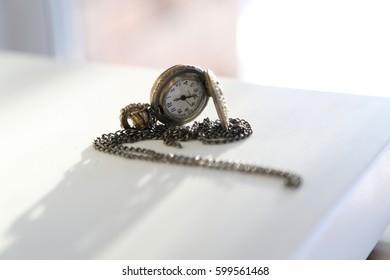 Small clock on a chain