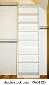 A Small Closet Interior Showing The Organizer Shelving And Rods.