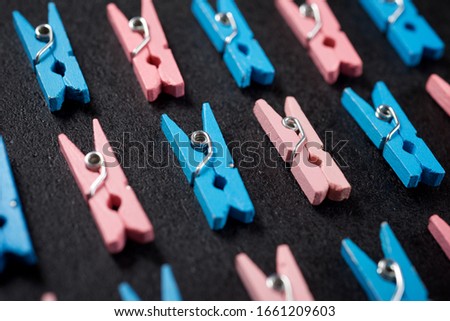 Small clothespins on a black table.