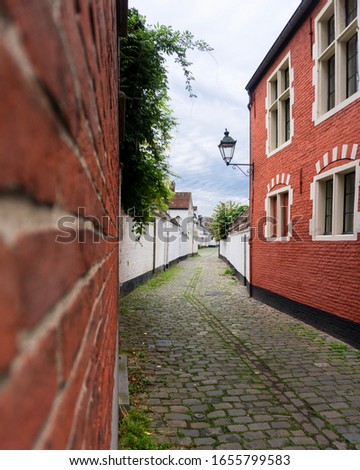 Small cobbled street and red brick houses in Ghent, Belgium