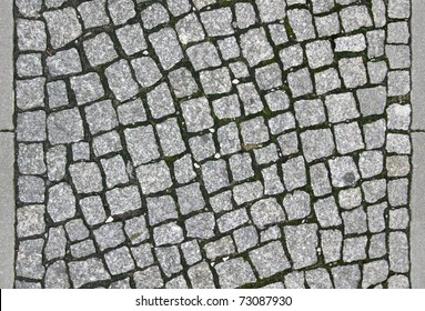 small cobblestone sidewalk made of cubic stones - tileable texture