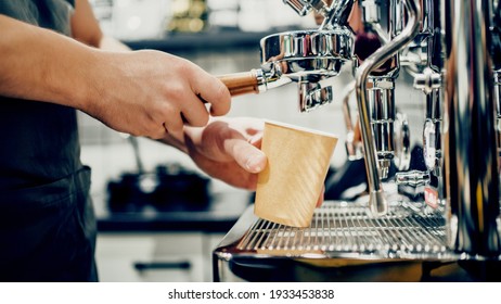 A small coffee business. Makes espresso, Americano with a takeaway. A professional barista prepares coffee in a carob coffee machine. Favorite job in the restaurant industry. - Powered by Shutterstock