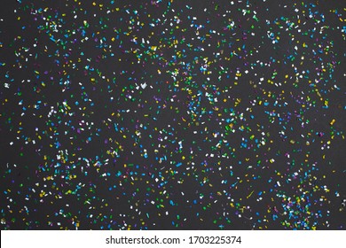 Small color microplastics and plastic parts Background on black background. Microplastic problem. Toxic substances.