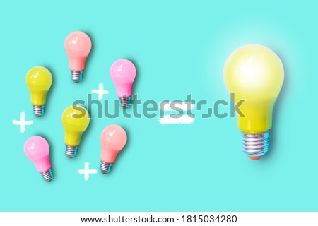 Small colorful light bulbs and plus sign on the left and a large yellow shiny light bulb on the right , represent synergy ,teamwork and collaboration for success output concept