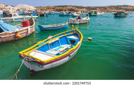 Small Colorful Maltese Fishing Boats Moored In Marsaxlokk Harbor, Malta