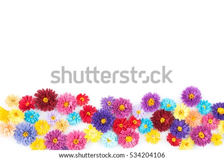 Small, colorful paper flowers made with quilling technique on white background.