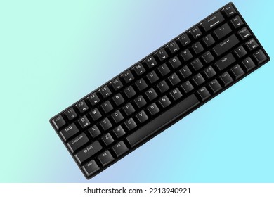Small compact black gaming computer keyboard blue gradient background  Wireless keyboard and mechanical switches for gadgets   computer  Diagonal  Copy space  Close  up