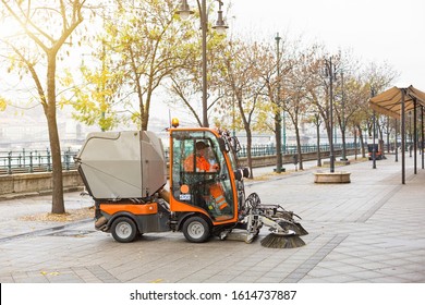 Small, compact, multifunctional municipal vacuum utility sweeper sweeper cleans Budapest street