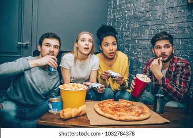 A Small Company Sitting Together Where Boys Are Drinking Some Coke While Girls Are Playing The Game. The Game Is Very Intense. Gamers. Night Party.