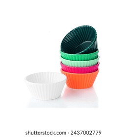 Small containers to serve cupcakes, appetizers, snacks and other food entrees. Colored muffin cases, cups, cuisine muffin tins, recipes foe pastry at home, celebration isolated on white backgrorund